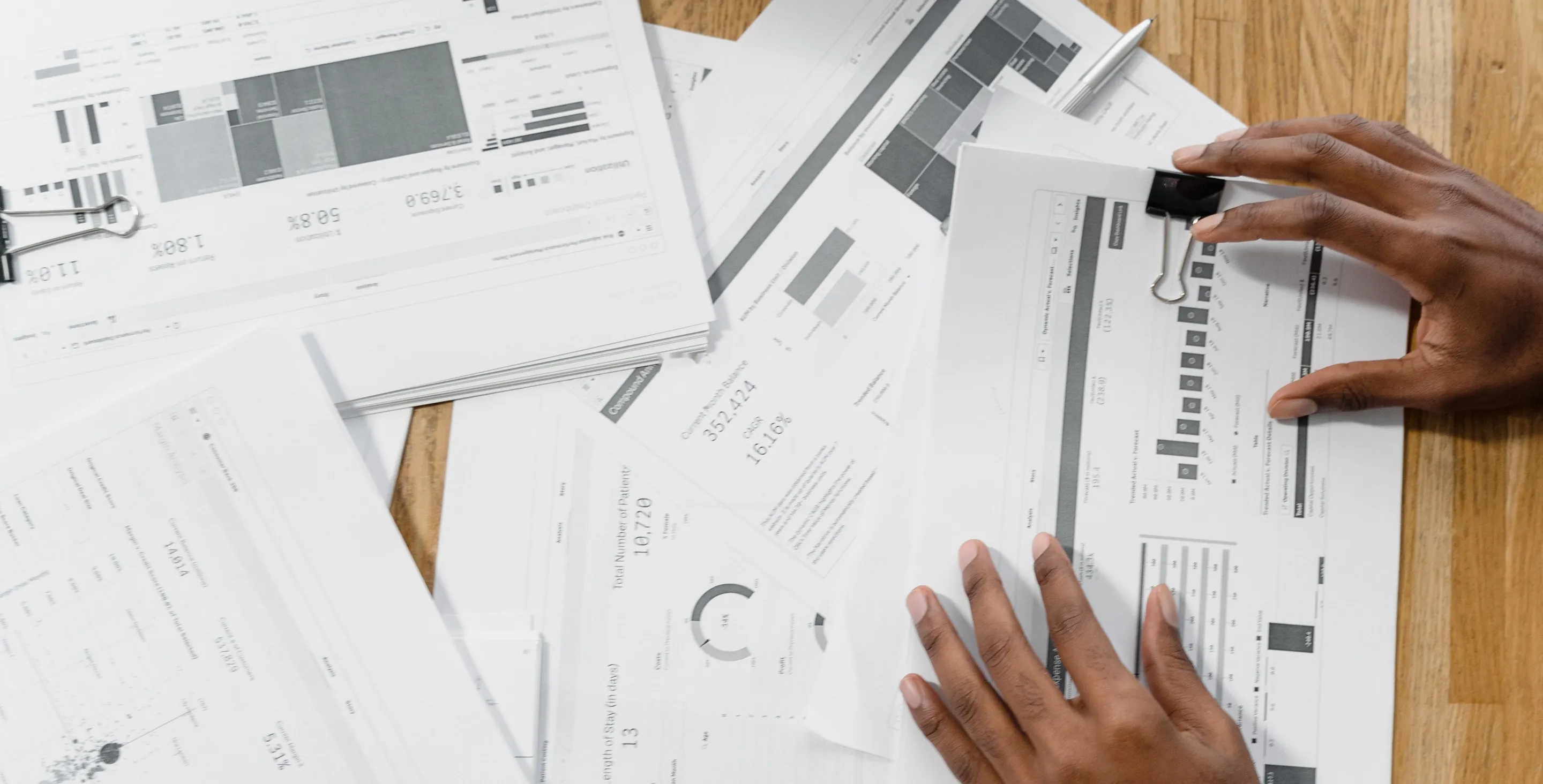 Printed charts and figures spread across a desk